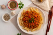 © Kritchai - Penne macaroni with Meat and sausage sauce,Easy Penne pasta tossed with a simple tomato sauce with ground pork and sausage in a plate.Top view.