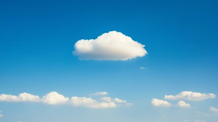 Aufkleber - A fluffy white cloud floats peacefully in a vast, bright blue sky. Surrounding clouds add depth to the scenery, creating a tranquil and isolated atmosphere at midday
