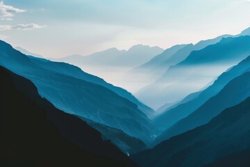 Aufkleber - Majestic mountain valley at dawn showcasing layered peaks, misty depths, and soft hues