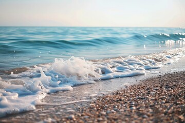 Poster - Gentle waves lap against a sandy shore under bright sunlight near a tranquil ocean