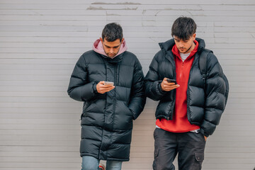 Wall Mural - young people on the street with mobile phones