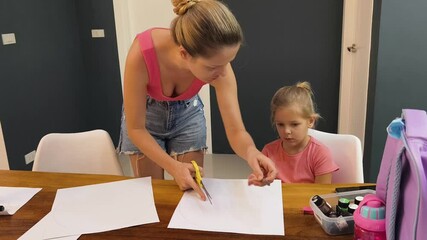 Wall Mural -  A mother and her young daughter engage in a colorful painting activity 