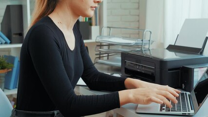 Poster - woman using printer to print documents in modern home office with laptop on desk and organized works