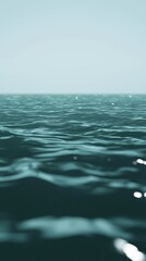 Poster - Serene teal ocean waves gently rolling under a clear sky, creating a tranquil and peaceful maritime scene, perfect for evoking a sense of calmness and vastness