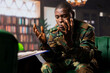 © DC Studio - African american army veteran in camouflage discusses emotional challenges with a therapist, representing mental health care for PTSD and war related stress disorder. Shell shock support.