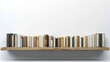 © AT10 - Books on wooden shelf against white wall