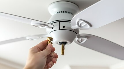 Installing ceiling fan with white blades and metal fittings