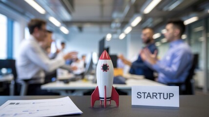 Poster - A startup meeting with a rocket model symbolizing innovation and growth.