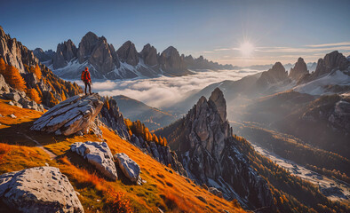 Fototapete - Person is standing on a rock in the mountains. The sun is shining brightly in the sky