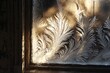 © Sana - Frosty patterns on a windowpane with sunlight streaming through, creating a magical effect