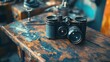 © milenialdesastudio - A vintage camera sits on a wooden table in a workshop, surrounded by other tools and equipment.
