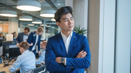 Poster - A professional man in a blue suit stands confidently in a modern office environment.