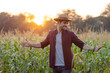 © kamonrat - Farmer Enjoying the Sunset in a Cornfield, Embracing Nature and the Golden Light, Representing Connection with the Land, Agriculture, and Peaceful Moment at the End of a Productive Day