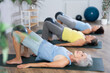 © JackF - Group of elderly women practicing pilates with soft ball in fitness studio