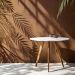 © Tekin - White table on brown wall background. Composition with leaves shadow on the wall and light reflections. Mock up for presentation, branding products, cosmetics food or jewelry.