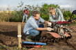© JackF - Male farmer shows his son how to fix garden cultivator. Farmer and a guy are repairing a machine to cultivate the soil with tools. Breakdown and repair of garden equipment on the farm © JackF - Male farmer shows his son how to fix garden cultivator. Farmer and a guy are repairing a machine to cultivate the soil with tools. Breakdown and repair of garden equipment on the farm