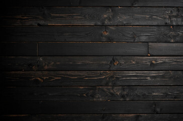 Wall Mural - A black wooden background with a few brown spots