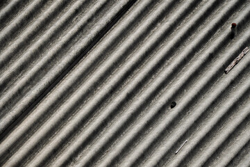 Poster - Close-up view of a weathered corrugated roof. The texture and lines are prominent. Corrugated Roof Texture.