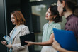 © qunica.com - Three professional women discussing ideas during an outdoor business meeting. Two hold notebooks, sharing insights with confidence and collaboration in a modern work environment.