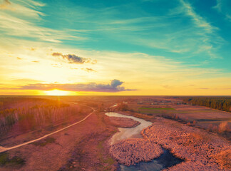 Wall Mural - beautiful sunset in the countryside in spring with the gradient sky. rural landscape in the evening.