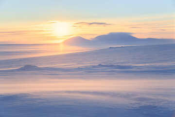 Wall Mural - winter arctic landscape. view from a snowy slope of a hill to the tundra and mountains. cold windy w