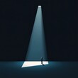© Petchladda - A man stands in a dark room with a spotlight shining on him