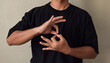 © syahrir - Young man learns sign language to talk, hand gestures of people with hearing impairment