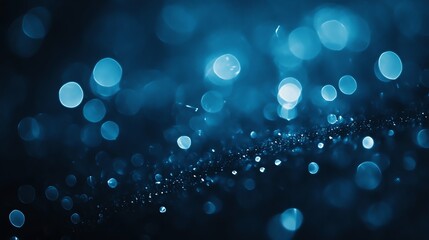 Abstract background of blurred blue bokeh lights.