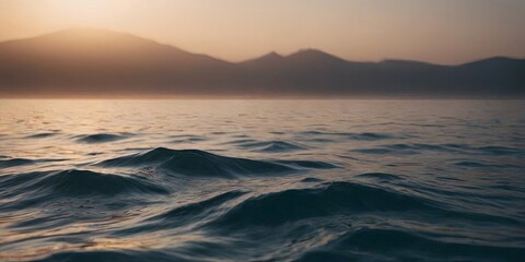 Aufkleber - The ocean is calm and the sun is setting behind the mountains
