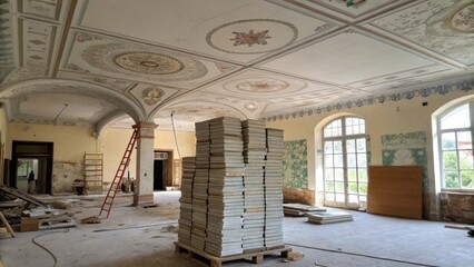 Poster - An unfinished ceiling of a room with a towering stack of tiles waiting to be mounted surrounded by remnants of old designs faintly visible on the walls.
