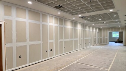 Aufkleber - An expansive blank slate featuring smooth drywall meticulously taped and sanded with a sense of potential radiating throughout the quiet space.