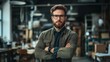 © Juan - Confident man with glasses in a modern workspace