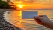 © Indri - Blank Card Held Against Sunset Beach Scene