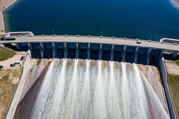 Wall Mural - A large body of water with a bridge and a series of waterfalls