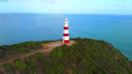 Wall Mural -  lighthouse is on a hill overlooking the ocean