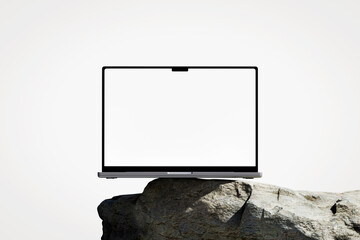 Wall Mural - scene with a opened laptop with a white blank screen on the rock