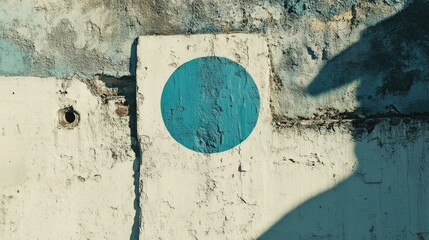 Aufkleber - Blue circular paint spot on an aged white wall with textured surfaces and shadows creating a rustic urban aesthetic.