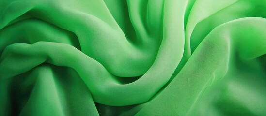 Poster - Bright green fabric texture showcasing soft folds and smooth surfaces ideal for fashion or design backgrounds.
