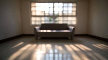 Aufkleber - Blurred contemporary living room with gray sofa showcasing light and shadow interplay in modern interior design setting