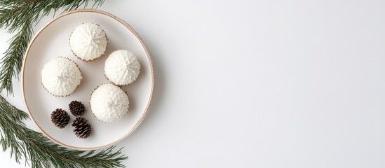 Aufkleber - Festive cupcakes on a plate surrounded by fir branches and pine cones creating a holiday wreath effect on a minimalistic white background
