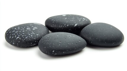 Poster - Smooth black beach stones arranged on a white background showcasing unique textures and patterns perfect for natural decor and design use