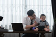 © Wosunan - A business father and his duty to take care of his children while working
