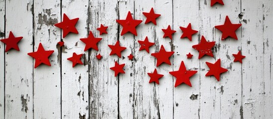 Poster - Christmas decoration with red stars on distressed white wooden background ideal for festive greeting card or holiday themed designs