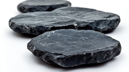 Poster - Smooth black stones arranged elegantly on a clean white background, emphasizing texture and shape, minimalist design, natural elements, spa, relaxation.