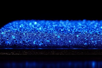 Poster - Close-Up View of Sparkling Blue Glitter Surface with Shimmering Particles and a Glossy Finish Against a Dark Background, Ideal for Abstract and Creative Designs