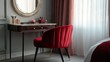 © Suphawan - Petite red velvet chair in a dressing room, positioned in front of a vintage vanity table
