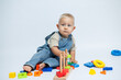 © DSMT - Baby boy playing with a puzzle sorter while playing in the nursery. Toys for developing fine motor skills of hands.