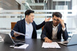 © Liubomir - Angry colleague yelling at a stressed employee in a modern office setting. This scene captures workplace conflict, frustration, and pressure as they engage in a heated discussion over paperwork.