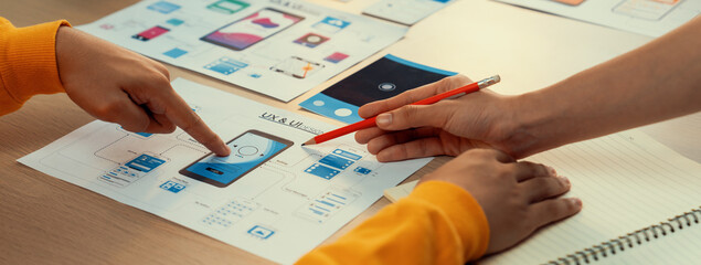 Poster - panorama banner of startup company employee planning on user interface prototype for mobile applicat