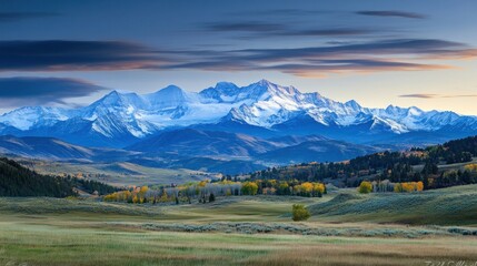 Poster - Majestic snow-capped mountains at sunrise over autumnal valley.